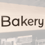 Modern collection wall copy dimensional letters for Bakery department wayfinding. Copy has aluminum face and finished edges.