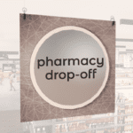 Modern Collection's large department sign with digitally printed text "pharmacy drop-off" centered on a circular overlay.
