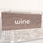 Modern Collection's singled sided small hanging dept sign with digitally printed white dimensional centered text "wine."