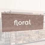 Modern Collection's singled sided small hanging department sign with digitally printed white dimensional text "floral."