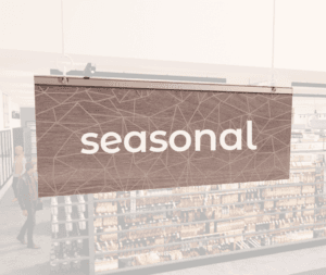 Modern Collection's singled sided small hanging department sign with digitally printed white dimensional text "seasonal."