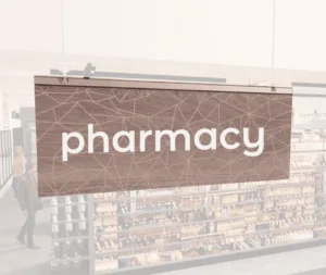 Modern Collection's singled sided small hanging department sign with digitally printed white dimensional text "pharmacy."