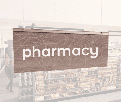 Modern Collection's singled sided small hanging department sign with digitally printed white dimensional text "pharmacy."