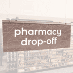 Modern Collection's singled sided small hanging dept sign with digitally printed white dimensional text "pharmacy drop-off."