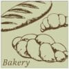 Traditional Collection's wayfinding dept sign with a pale sage face and brown text that reads "Bakery," and illustrated loaves
