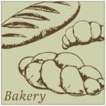 Traditional Collection's wayfinding dept sign with a pale sage face and brown text that reads "Bakery," and illustrated loaves