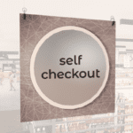 Modern Collection's hanging self-checkout section wayfinding sign with a centered circular overlay & black dimensional text.
