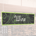 Natural Collection's hanging department sign with text reading "Wine" for Wine or Alcohol Department Wayfinding.
