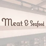 Natural Collection's wall mounted wood letters with a painted finish to be used as a "Meat & Seafood," wayfinding sign.