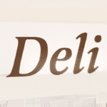 Traditional Collection's wayfinding Deli dept sign that is wall mounted with dimensional wood letters & a painted finish