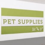 Pet Supplies Department Sign for a pet department has cut out text revealing color beneath and dimensional icons.