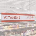 Vitamins section short department sign in the Iconic Collection's cheerful color scheem