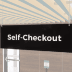 Self-checkout sign with a black background and white text. Double sided sign from Shop2It Retail.
