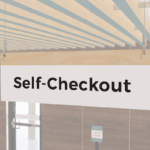 White Self-Checkout sign with black text and a woodgrain stripe at the top. double sided. from Shop2it Retail.